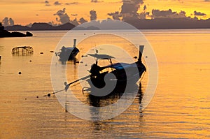 Longtail boat on the sea at sunriseÂ in Adang-Ravi Islandsin,Tarutao National Park, Satun Thailand